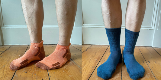 Alpaca ankle socks that are orange are on the left and blue alpaca crew socks on the right