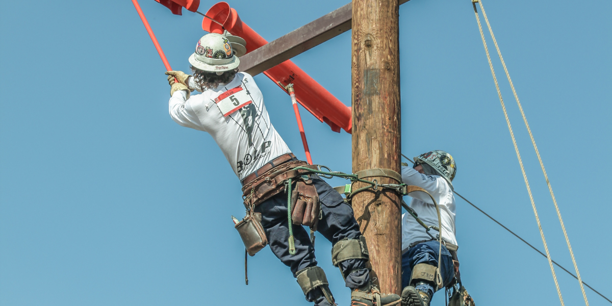 Two guys work on power lines 