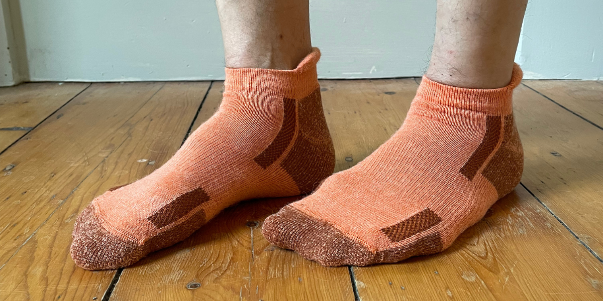 Orange alpaca ankle socks are shown with dark orange accents