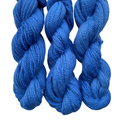 Three skeins of blue yarn on a white background