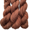Three skeins of brown yarn on a white background